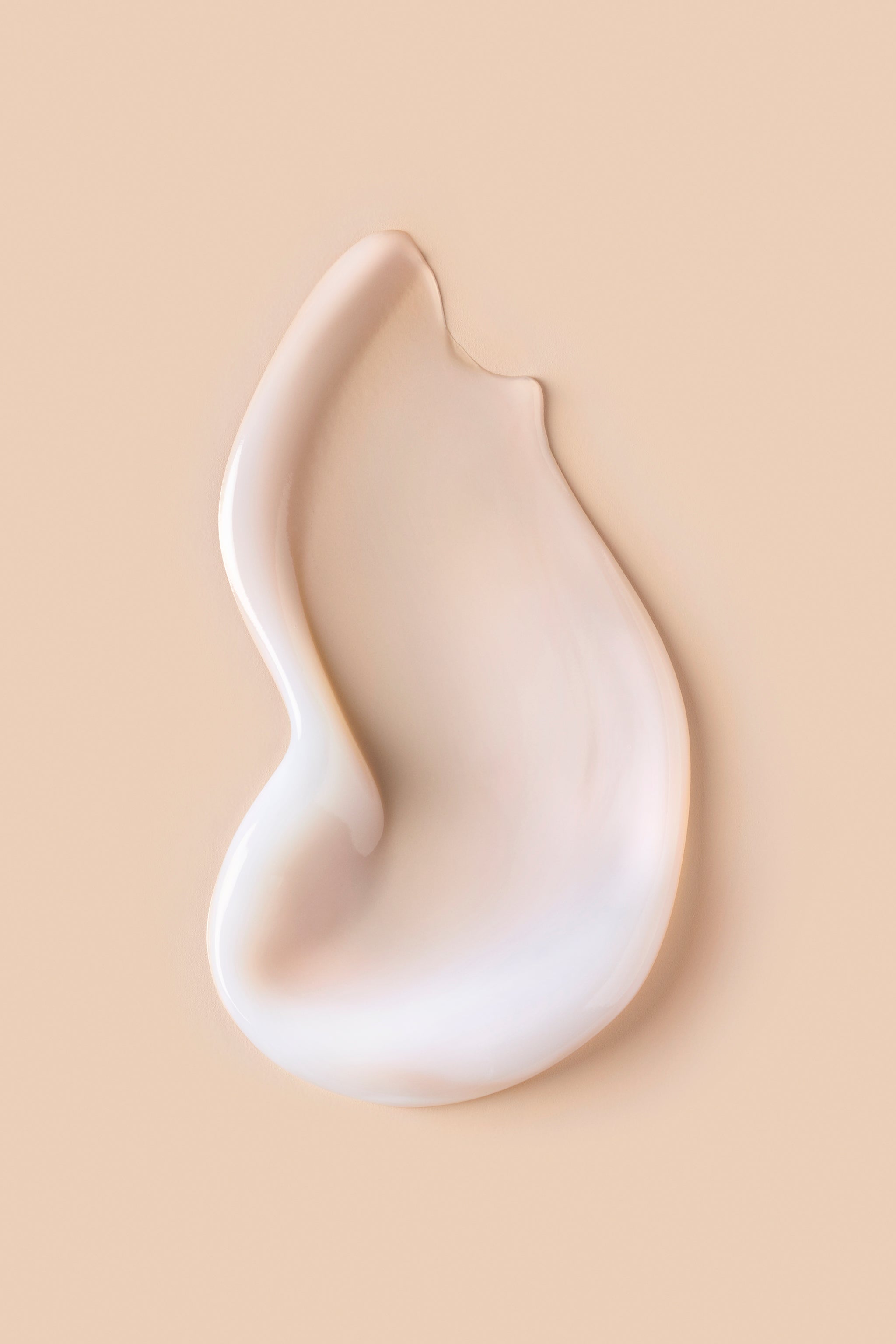 Portion of white Curl Shaper Out of Thin (H)air Volumizing Jelly on beige background