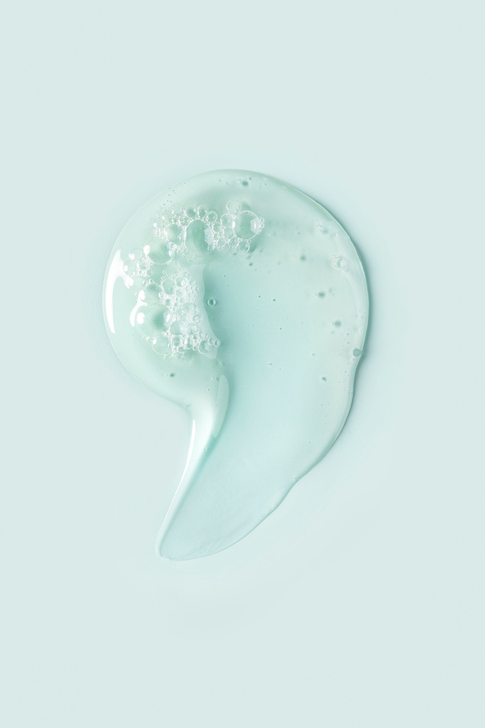 Portion of VitalCurl®+ Clean and Clear Shampoo on light blue background
