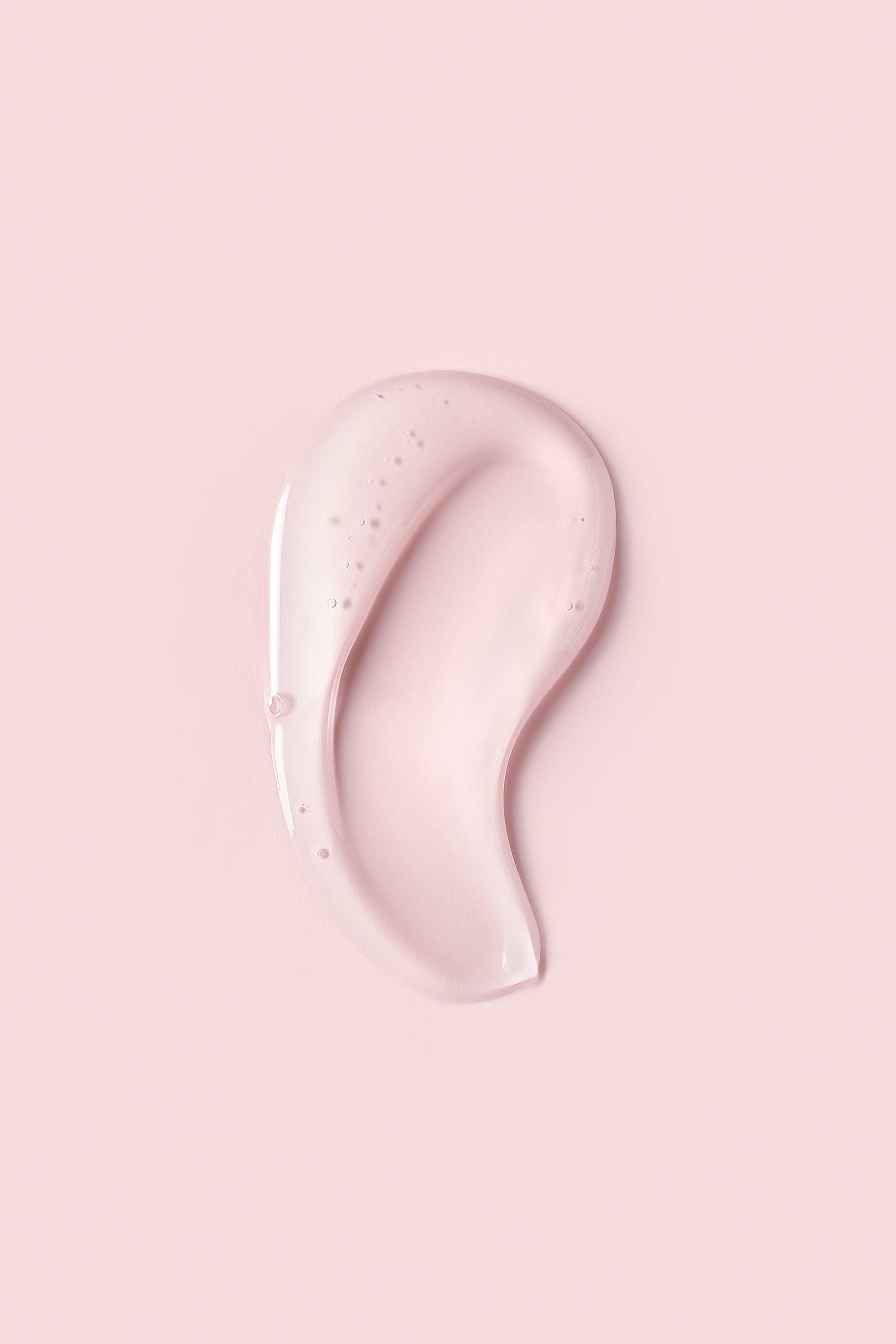 Portion of clear Advanced Climate Control® Heat & Humidity Gel - Stronger Hold on pink background