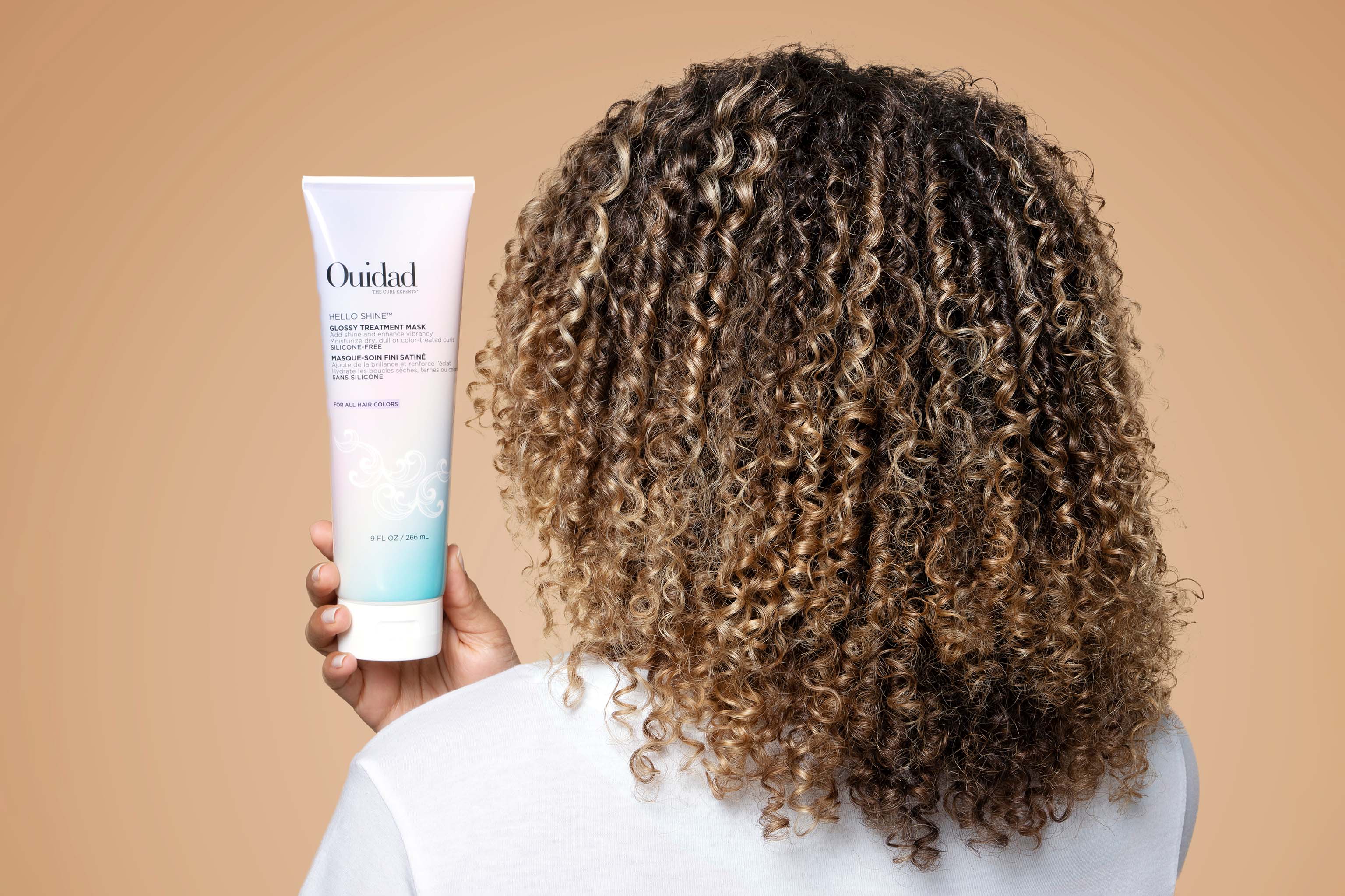 Modeling holding Hello Shine™ Glossy Hair Treatment Mask